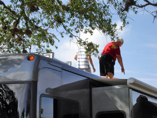 Lee and Brian Duquette on top of the RV